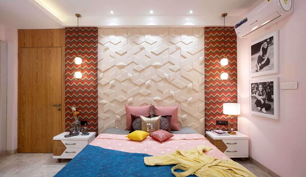 Modern bedroom wall design in Vizag featuring wooden fluted wall panels, upholstered headboard, LED lighting, luxury bed, and elegant bedroom interiors by SpaceHeaven Interior.