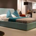 Modern bedroom designs featuring a luxury bed, custom wardrobe, elegant lighting, wooden wall panels, and premium bedroom interior design in Vizag.