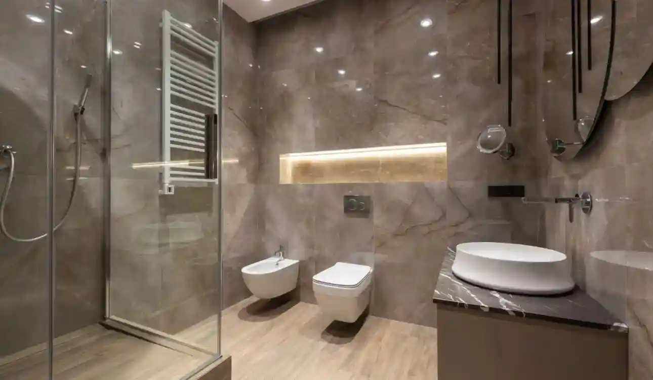 Modern bathroom designs in Vizag with contemporary tiles, vanity and walk-in shower